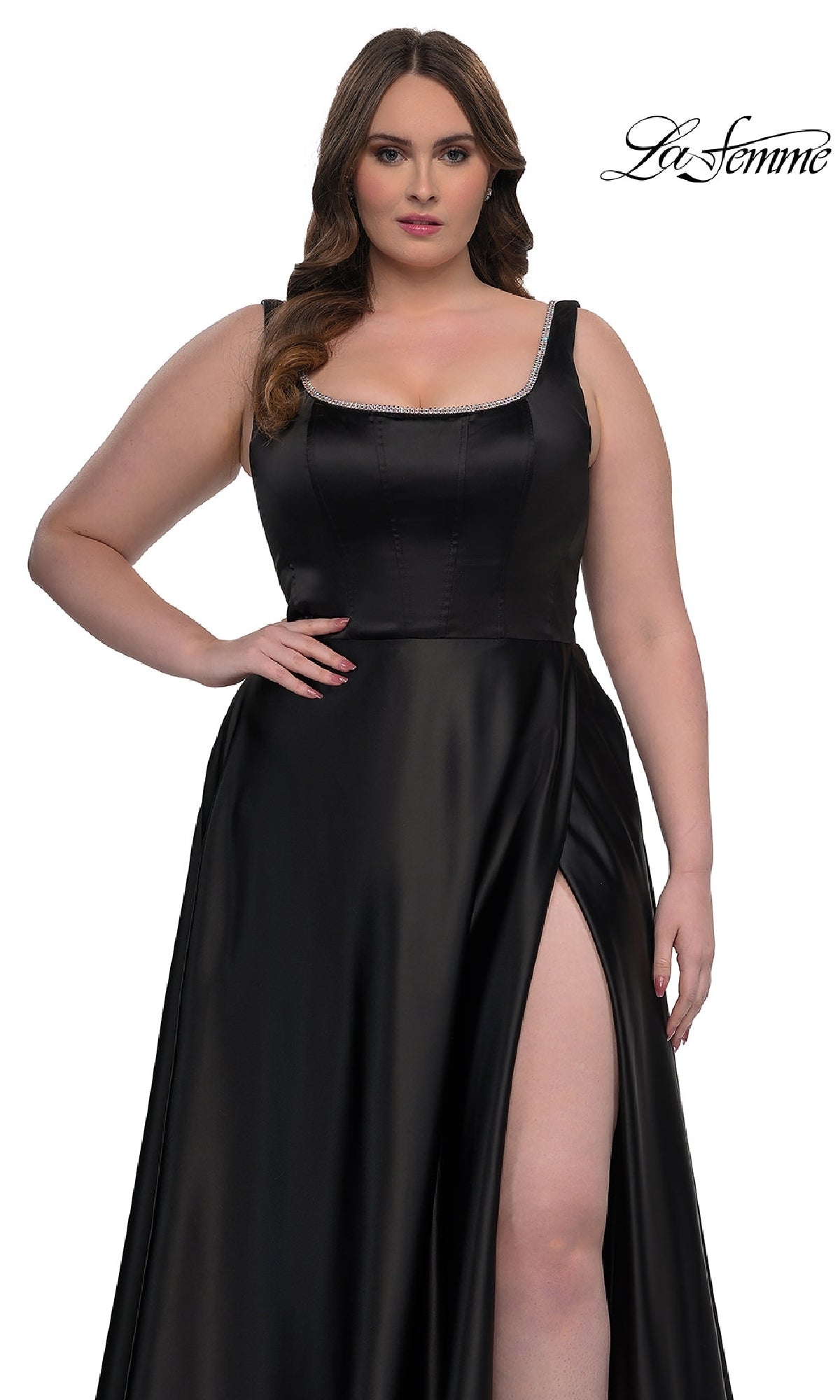 A woman models the Plus-Size Classic Long Prom Gown, La Femme 33026—a sleeveless black satin dress with a high slit—against a white background. The La Femme logo appears in the top right corner.